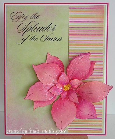 copyright linda @ snail's space and described here for people with disabilities; christmas card with large pink poinsettia on green background with pink border and pink, orange and green striped strip along the right hand side of the card